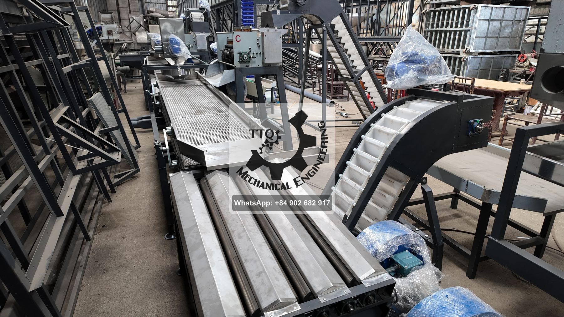 A TTQ scooping line in build — perforated separation deck, roller section and a bucket elevator