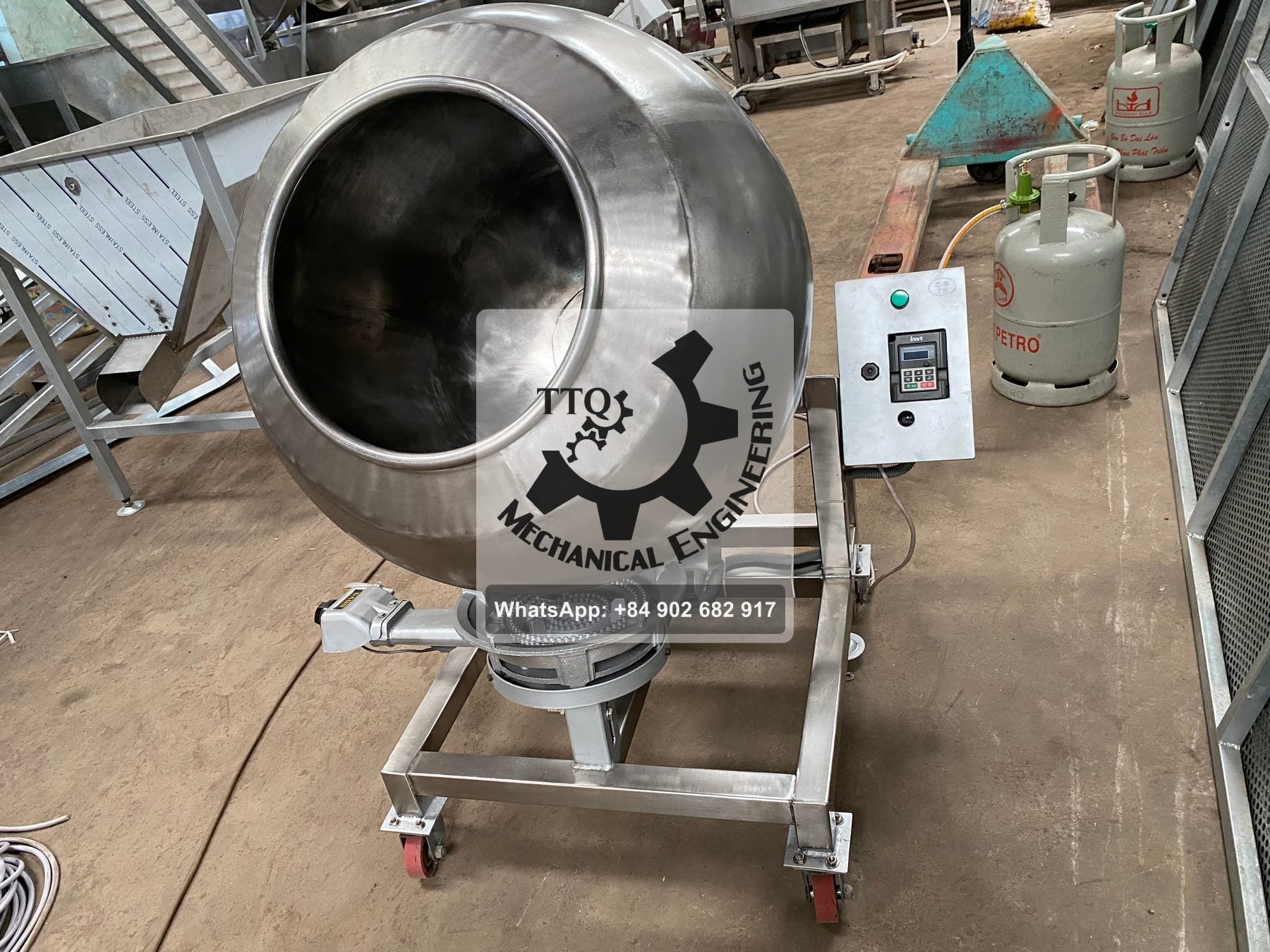 Stainless sugar-coating pan on a castored frame, gas ring burner beneath and a variable-frequency drive alongside